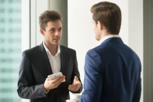 Reporting Mold in the Workplace - Two Men Talking About Something at Work