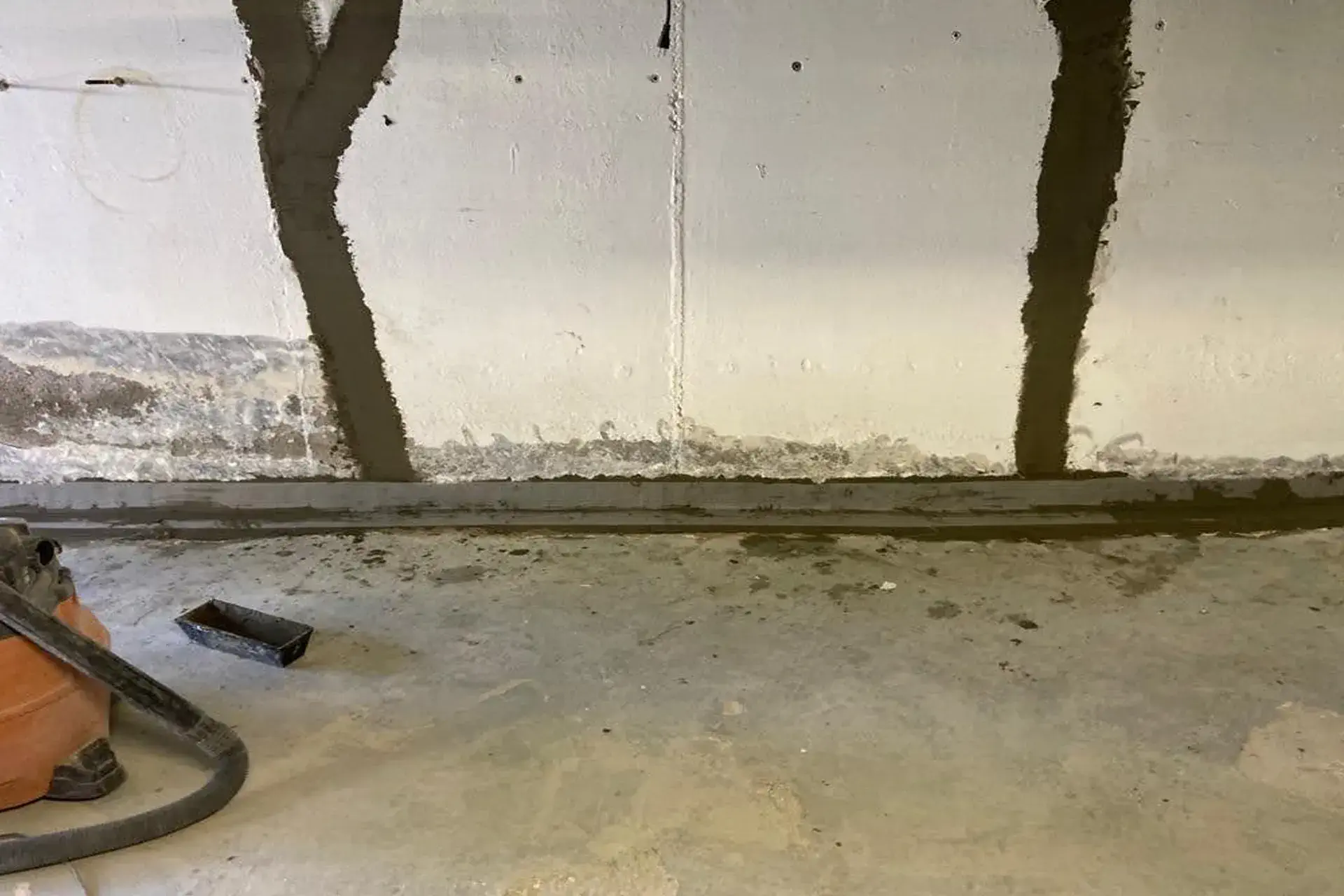 Moisture Problems in Basement - A Picture of a Wet Basement with a Crack Repair and Waterproofing Project in Progress by Zavza Seal