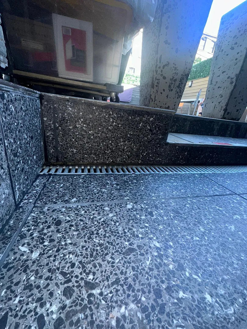 Exterior Drainage Solutions - A Picture of a French Drain on a Patio