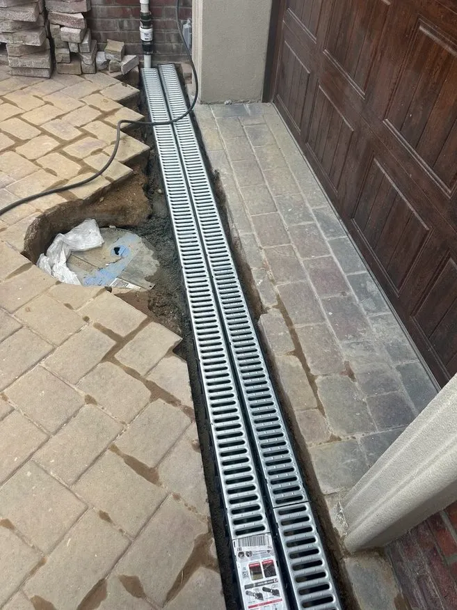 Exterior Drainage Solutions - A Trench Drain Installed Along the Side of a House